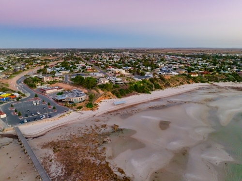 Aerial view of a coastal town above a sandy beach and coastline