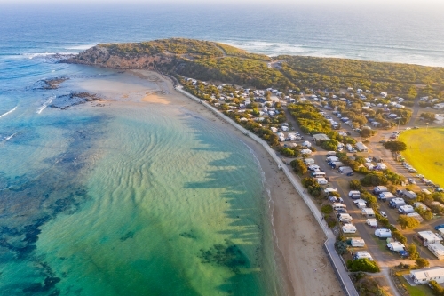 Aerial view of a coastal town and caravan park near a river mouth - Australian Stock Image