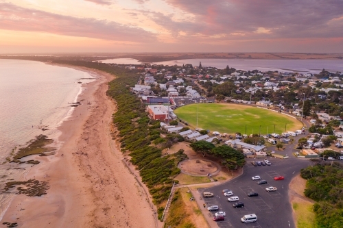 Aerial view of a coastal town and sporting oval at sunset - Australian Stock Image