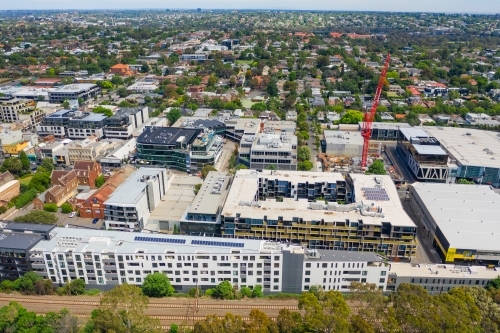 Aerial view of a construction crane over apartment block in a city suburb