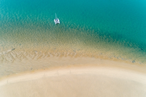 Aerial view of a cruising catamaran anchored near a sandbar, Seventeen Seventy, QLD. - Australian Stock Image