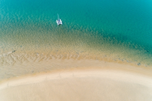 Aerial view of a cruising catamaran anchored near a sandbar, Seventeen Seventy, QLD.