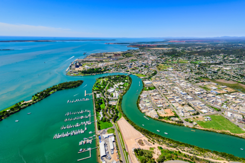 Aerial view of a Gladstone coastal town surrounded by winding waterways from Callemondah area - Australian Stock Image