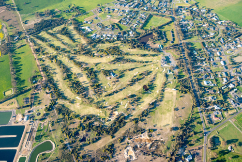 Aerial view of a golf course beside a regional town landscape. - Australian Stock Image