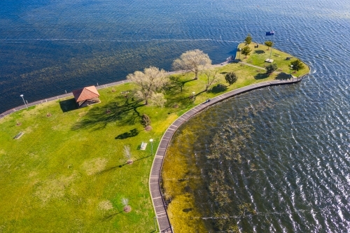Aerial view of a green reserve around the shores of an inner city lake - Australian Stock Image