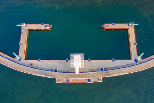 Aerial view of a large diving platform above a circular swimming enclosure - Australian Stock Image