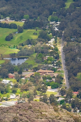 Aerial view of a regional town nestled in a tree lined valley