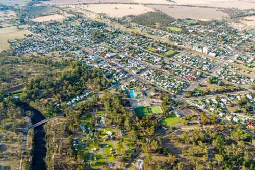 Aerial view of a rural township surrounded by open farmland and scattered bushland - Australian Stock Image
