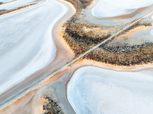 Aerial view of a salt lake with a pedestrian walkway running diagonally through the image - Australian Stock Image