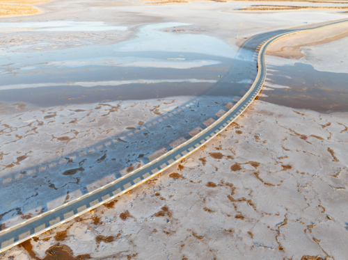 Aerial view of a salt lake with a pedestrian walkway running diagonally through the image - Australian Stock Image