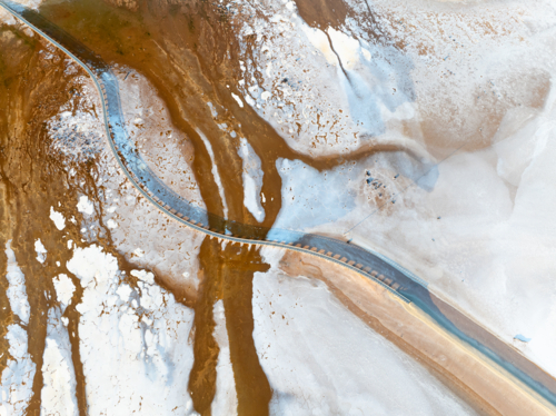 Aerial view of a salt lake with a pedestrian walkway running diagonally through the image - Australian Stock Image