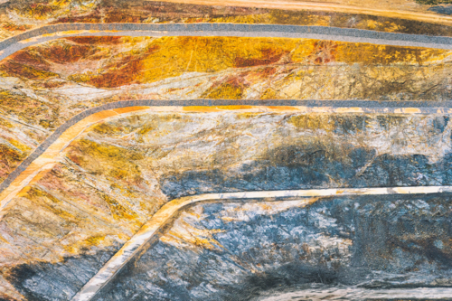 Aerial view of a terraced large open pit mine exposing earth layers - Australian Stock Image