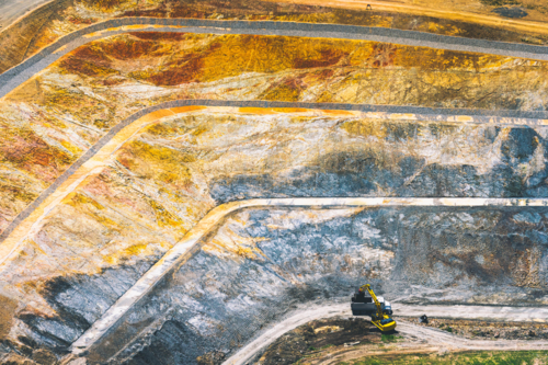 Aerial view of a terraced large open pit mine exposing earth layers - Australian Stock Image
