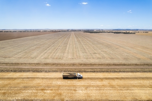 Aerial view of a vast farmland with distinct areas of varying shades of brown and beige. - Australian Stock Image