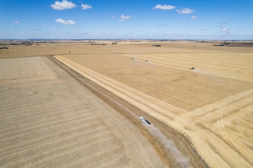 Aerial view of a vast farmland with distinct areas of varying shades of brown and beige. - Australian Stock Image
