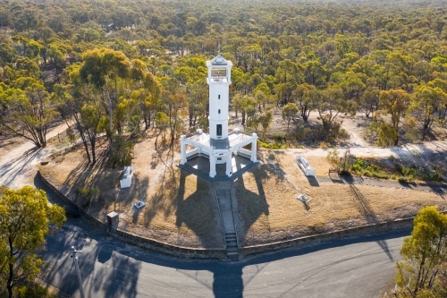 Aerial view of a white lookout tower on a hill top