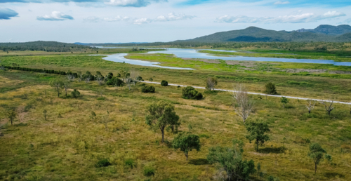 Aerial view of a winding river cutting through a lush, green landscape - Australian Stock Image