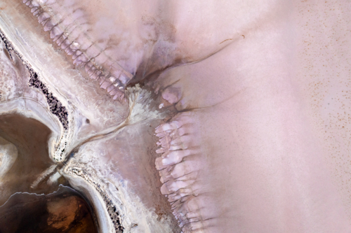 Aerial view of abstract salt lake patterns in soft pink and beige tones - Australian Stock Image