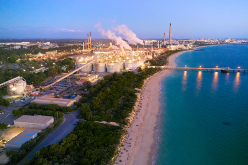 Aerial view of Alumina refinery along the coastal scrub and sandy beach. - Australian Stock Image