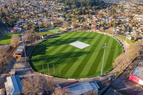Aerial view of an AFL football oval amongst suburban housing - Australian Stock Image