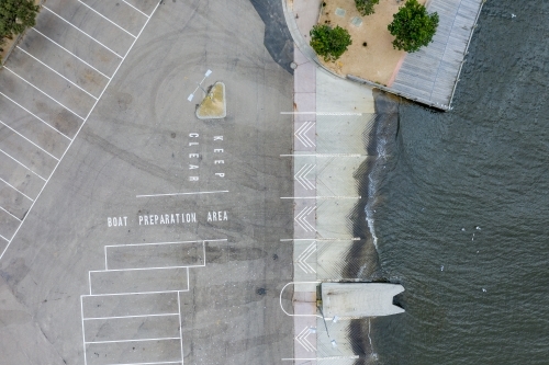 Aerial view of an empty car park at a bay side boat ramp - Australian Stock Image