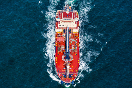 Aerial view of an oil tanker navigating through deep blue ocean waters on Sydney Harbour - Australian Stock Image