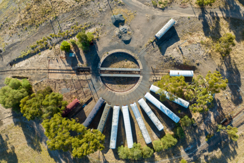 Aerial view of an old railway turntable with abandoned train carriages. - Australian Stock Image