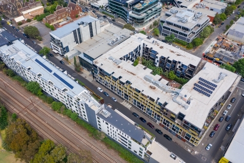 Aerial view of apartment blocks along an inner city railway line - Australian Stock Image