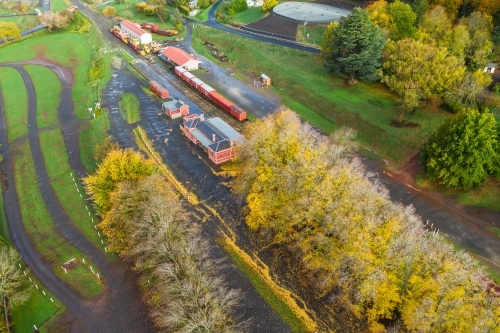 Aerial view of autumn trees surrounding an historic railways - Australian Stock Image