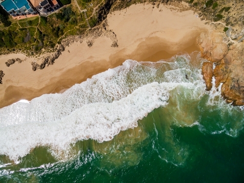 aerial view of beach in front of waterfront houses - Australian Stock Image