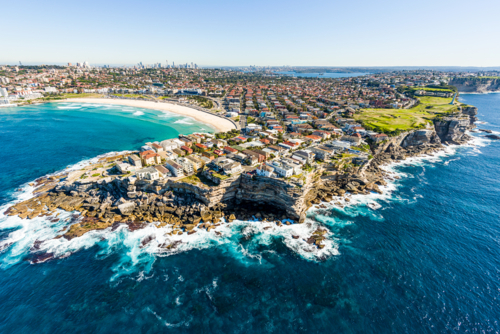 Aerial view of Bondi Beach and surrounding suburbs with cliffs and surf coastline - Australian Stock Image