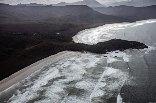 Aerial view of breaking waves and coastline at Cox Bight, South West Tasmania