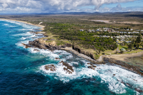 Aerial view of Brooms Head, Brooms Head Beach and Sand Dune Beach, showcasing the headland - Australian Stock Image