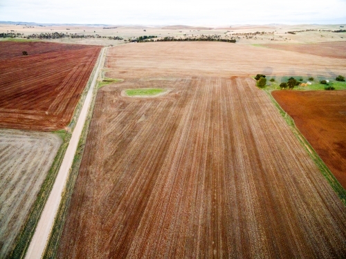 Aerial view of brown farmland after seeding - Australian Stock Image