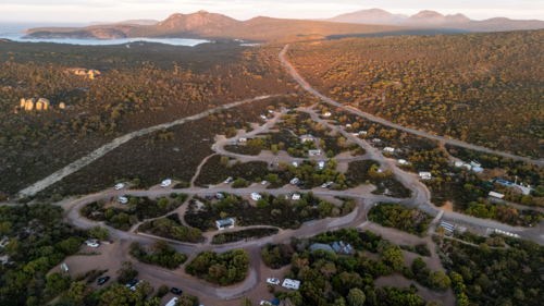 Aerial view of caravan park camping area by the coast - Australian Stock Image