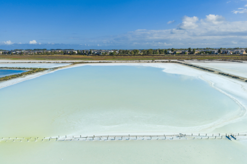 Aerial view of clouds reflected in a colourful coastal salt lake - Australian Stock Image