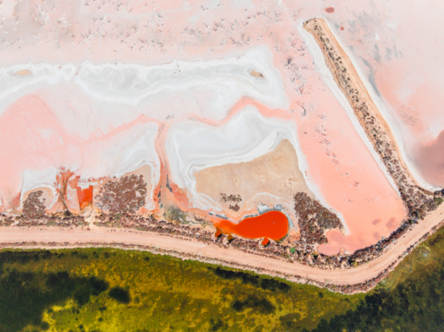 Aerial view of colourful salt evaporation pond and levee banks at a coastal salt farm - Australian Stock Image