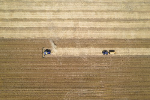 Aerial view of combine harvester in a field - Australian Stock Image