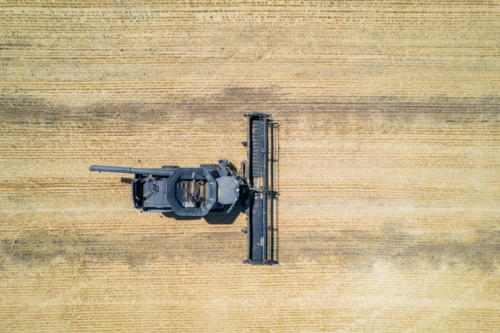 Aerial view of combine harvester in the field - Australian Stock Image