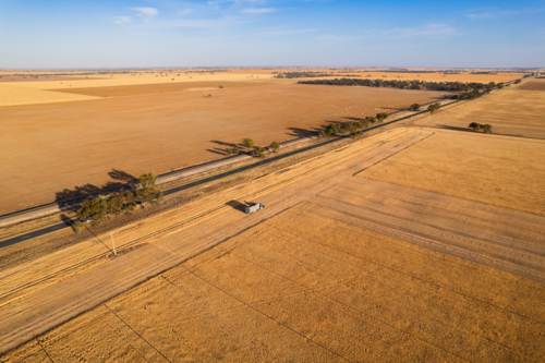 Aerial view of combine harvester on the field. - Australian Stock Image