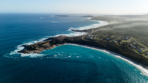 Aerial view of crescent shapes shoreline with turquoise water - Australian Stock Image