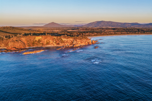 Aerial view of Diamond Head Beach and headland surrounded by ocean and coastal landscape - Australian Stock Image