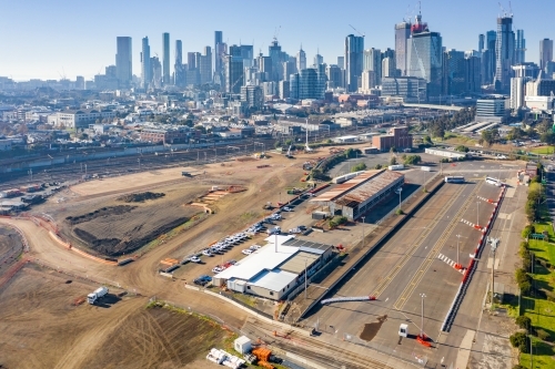 Aerial view of factories and vacant land in front of high rise buildings of a city