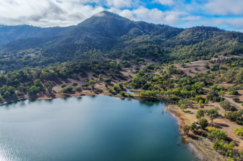 Aerial view of Glenbawn Dam and camping areas along the shoreline - Australian Stock Image