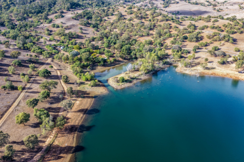 Aerial view of Glenbawn Dam and camping areas along the shoreline - Australian Stock Image