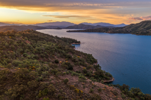 Aerial view of Glenbawn Dam at sunset in NSW Australia capturing calm dam waters - Australian Stock Image