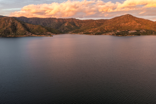 Aerial view of Glenbawn Dam at sunset in NSW Australia. Drone captures calm dam waters - Australian Stock Image