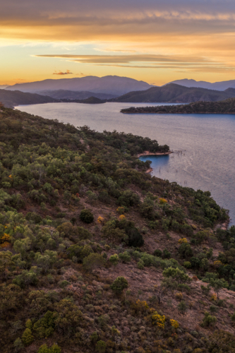 Aerial view of Glenbawn Dam at sunset in NSW Australia. Drone photograph captures calm dam waters - Australian Stock Image