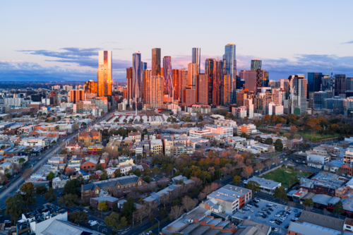 Aerial view of high rise buildings in a city skyline in golden evening lighting - Australian Stock Image