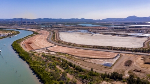 Aerial view of highway out of Gladstone with Mount Larcom in the background - Australian Stock Image